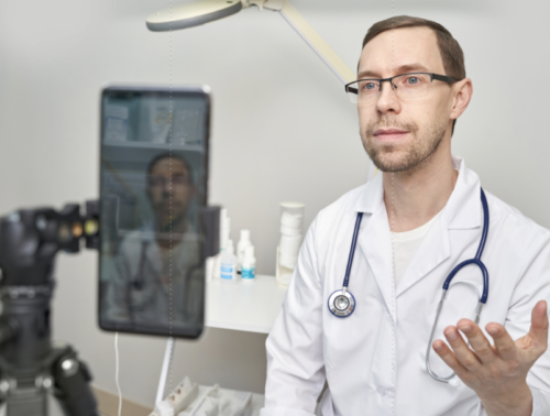 Doctor engaging with social media on a mobile device, showcasing healthcare presence online.